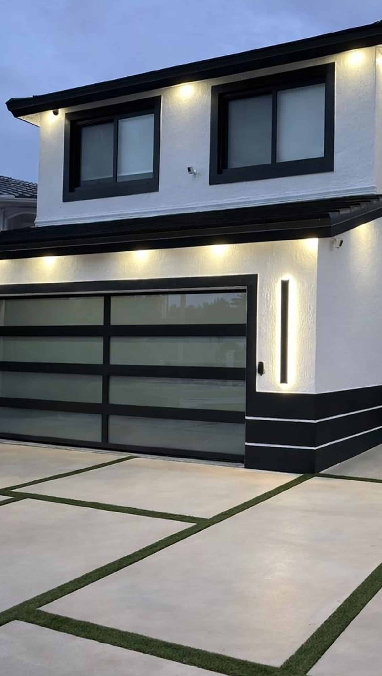 Contractors installing modern glass garage doors
